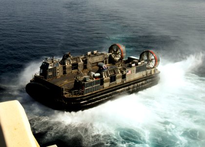 US Navy 081027-N-4236E-139 A landing craft air cushion (LCAC) from Assault Craft Unit (ACU) 4 disembarks from the multi-purpose amphibious assault ship USS Iwo Jima (LHD 7)