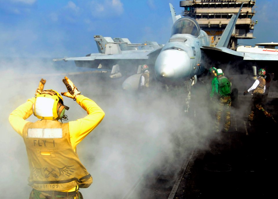 US Navy 081030-N-7571S-002 An Aviation Boatswain's Mate (Handling) directs an F-A-18 Super Hornet assigned to the