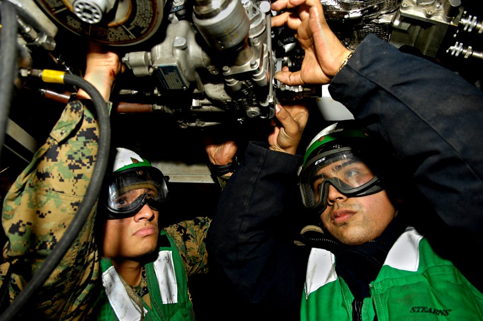 US Navy 081024-N-4954I-020 Lance Cpl. Abraham Cortes from Lompoc, Calif., left, assigned to Marine Aviation Logistics Squadron (MALS) 11, and Aviation Machinist's Mate Airman Jimmy Perez, from Long Beach, Calif., check electric
