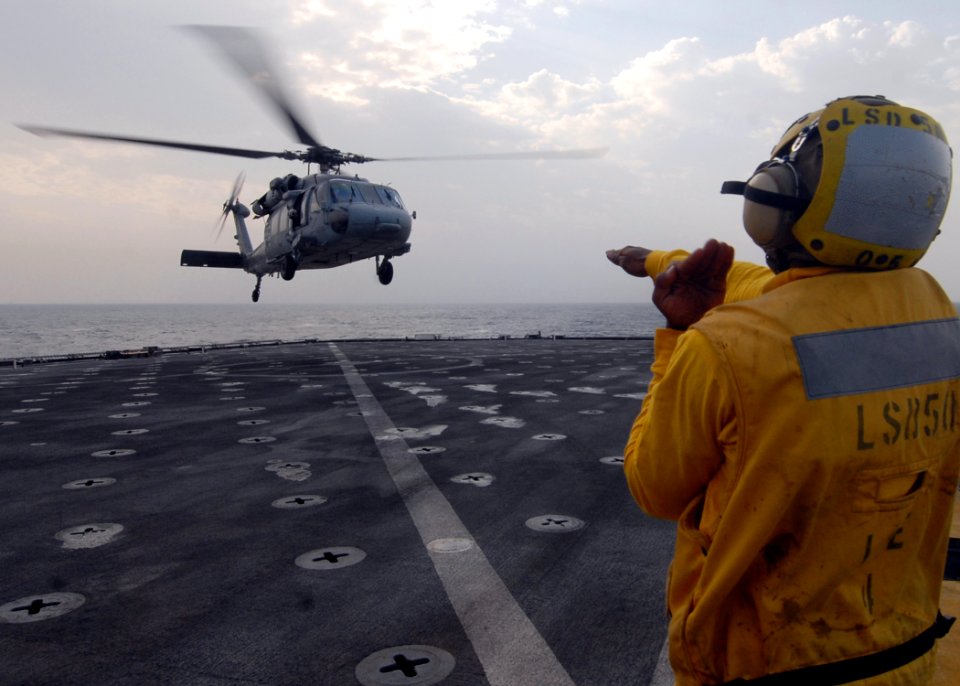 US Navy 081030-N-9134V-055 Seaman James Buchanan directs a MH-60S