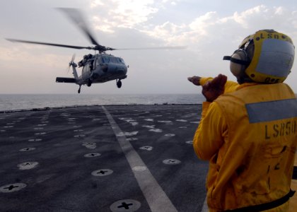 US Navy 081030-N-9134V-055 Seaman James Buchanan directs a MH-60S