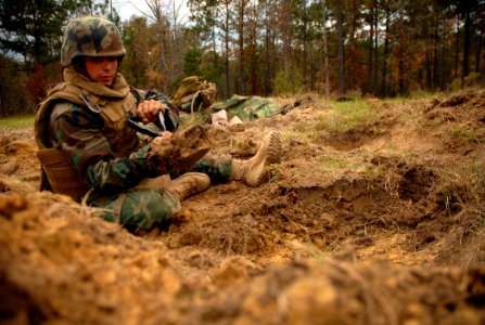 US Navy 081114-N-7367K-037 Builder 3rd Class Mitch Engelman digs a fighting position at a bridge site