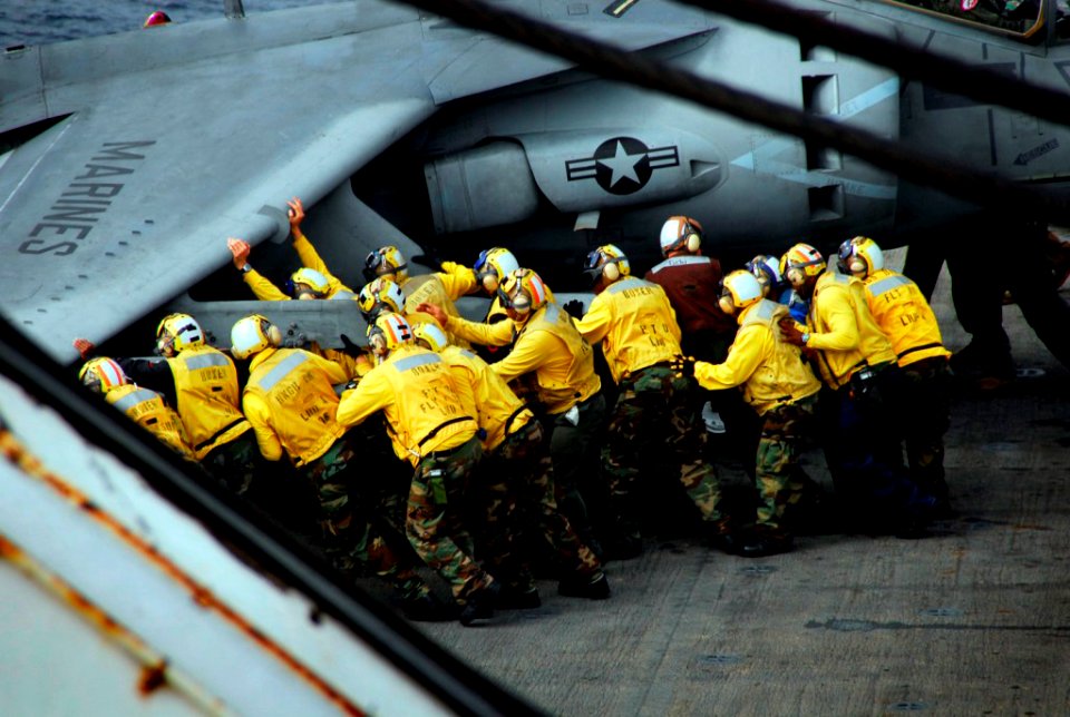 US Navy 081031-N-4774B-054 Flight deck crew members move an AV-8B Harrier II jet