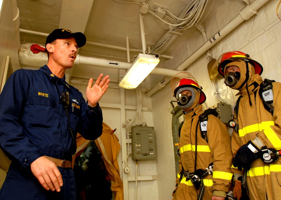 US Navy 081028-N-2456S-227 Chief Storekeeper Tim White, from San Diego, instructs Sailors how to properly battle a fire during a simulated general quarters drill aboard the aircraft carrier USS Theodore Roosevelt (CVN 71)