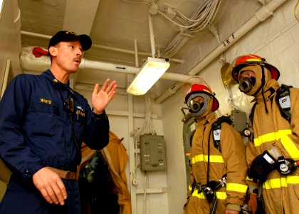 US Navy 081028-N-2456S-227 Chief Storekeeper Tim White, from San Diego, instructs Sailors how to properly battle a fire during a simulated general quarters drill aboard the aircraft carrier USS Theodore Roosevelt (CVN 71)