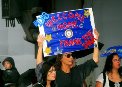 US Navy 081104-N-5148B-040 Family and friends wait on the pier to see Sailors assigned to the amphibious assault ship USS Peleliu (LHA 5)