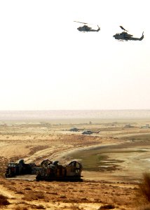US Navy 081028-N-4856C-109 A landing craft air cushion and two AH-1W Super Cobra helicopters participate in a bilateral training exercise