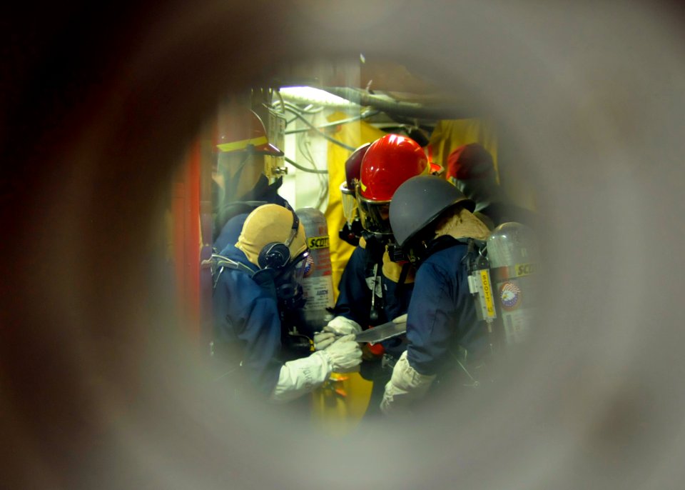 US Navy 081028-N-8546L-150 Sailors man a repair locker to fight a class bravo fire