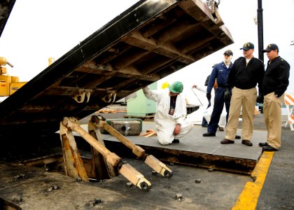 US Navy 081030-N-9898L-067 uget Sound Naval Shipyard worker Mike Main, from Port Townsend, Wash., checks the distance between a jet blast deflector and the flight deck of the aircraft carrier USS Abraham Lincoln (CVN 72) photo