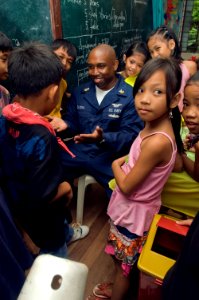 US Navy 081028-N-5253W-093 Aviation Boatswain's Mate (Handling) 1st Class David Clora plays with students of the New Cabalan Elementary School