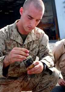 US Navy 081028-N-6764G-076 Lance Cpl. Matt Dillman loads a clip during a live fire exercise
