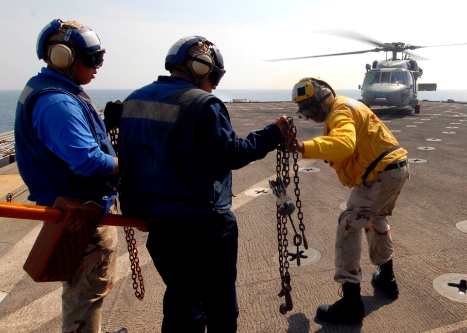 US Navy 081025-N-9134V-049 Seaman James Buchanan checks chocks and chains during flight quarters
