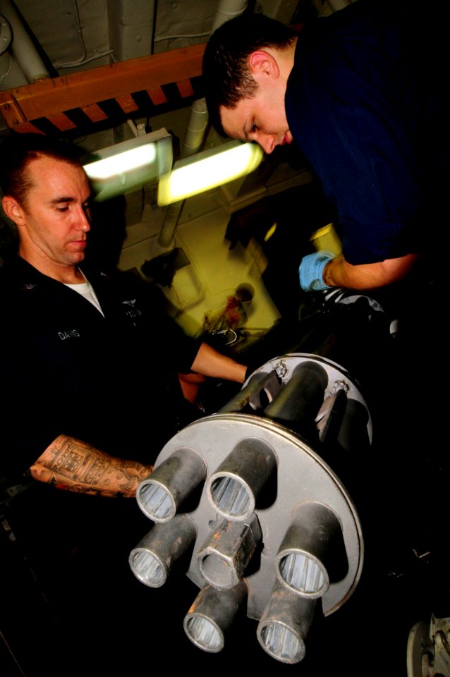 US Navy 081028-N-7918H-099 Aviation Ordnanceman 2nd Class Doug Davis and Aviation Ordnanceman Airman James Ballard conduct maintenance on an M61 A1 gun for an F18 Hornet