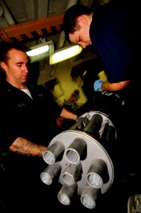 US Navy 081028-N-7918H-099 Aviation Ordnanceman 2nd Class Doug Davis and Aviation Ordnanceman Airman James Ballard conduct maintenance on an M61 A1 gun for an F18 Hornet