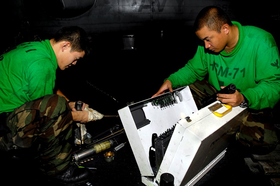 US Navy 081031-N-4954I-002 Aviation Machinist's Mate 3rd Class HuanChing Nieh cleans tools as Aviation Machinist's Mate 2nd Class Rayson nventories a tool box