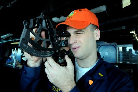 US Navy 081028-N-9774H-013 Ensign Timberon Vanzant determines the distance to another vessel through a stadimeter from the bridge of the amphibious assault ship USS Kearsarge (LHD 3) photo