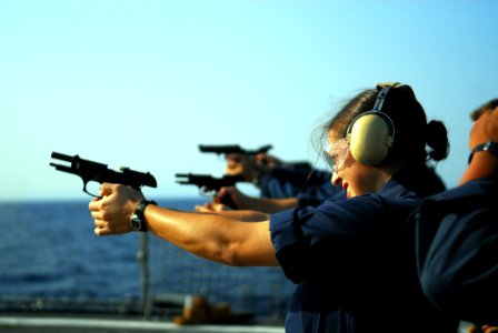 US Navy 081026-N-2013O-005 Ship's Serviceman 3rd Class Angela Muratalla fires the M9 9mm pistol