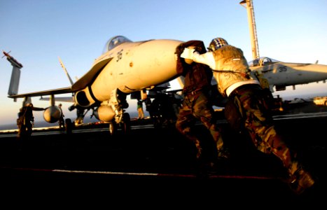 US Navy 081029-N-9928E-572 Sailors push an F-A-18C Hornet into the corral area of the flight deck