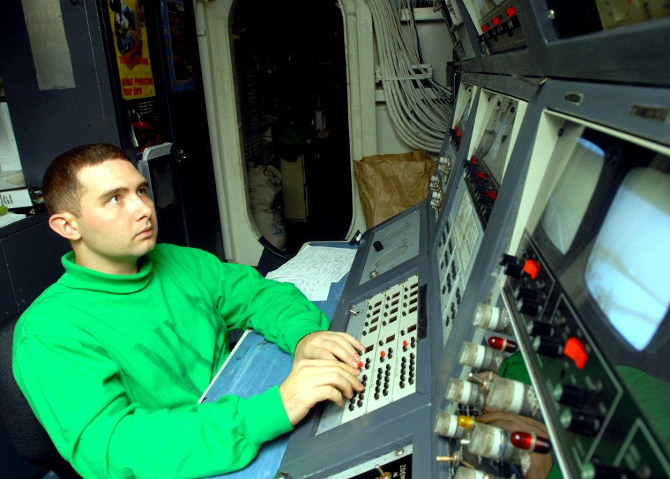 US Navy 081026-N-2456S-014 Interior Communications Electrician 3rd Class Daniel Whittington stands watch in the integrated launch and recovery television surveillance control room