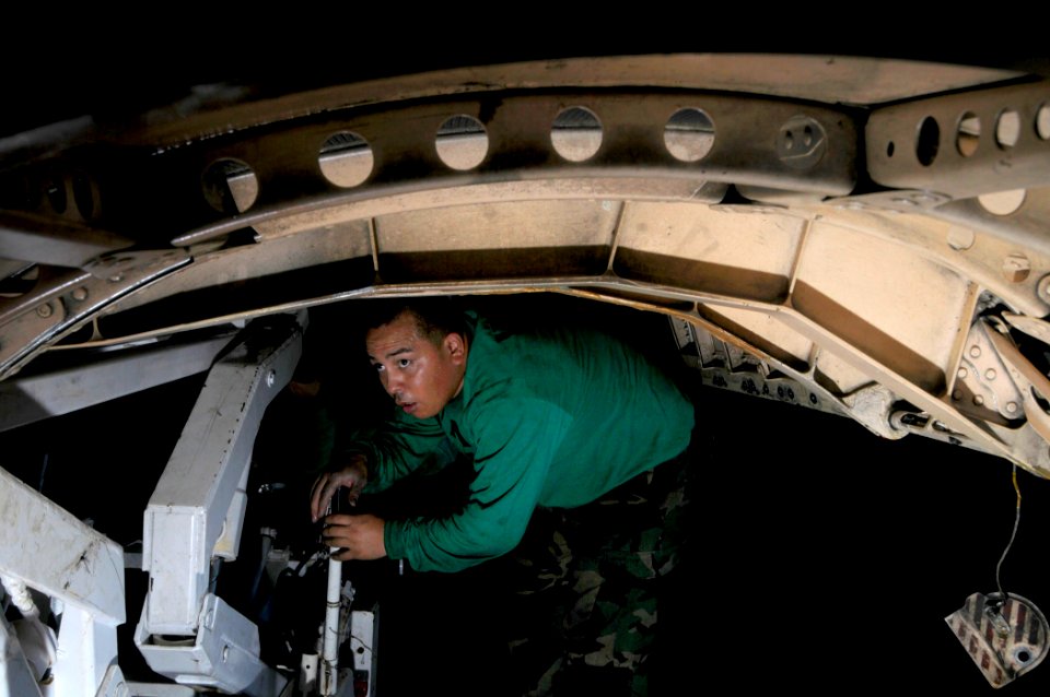 US Navy 081103-N-7918H-016 Aviation Machinist Mate Airman Dominic Valdez corks the quantum transducer on an F-A-18 Hornet aboard the aircraft carrier USS Theodore Roosevelt (CVN 71)