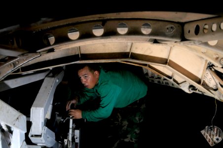 US Navy 081103-N-7918H-016 Aviation Machinist Mate Airman Dominic Valdez corks the quantum transducer on an F-A-18 Hornet aboard the aircraft carrier USS Theodore Roosevelt (CVN 71)