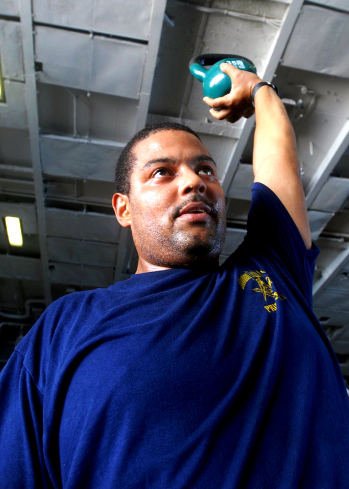 US Navy 081027-N-2456S-040 Machinist's Mate 1st Class Rory Rice exercises with the kettle bell
