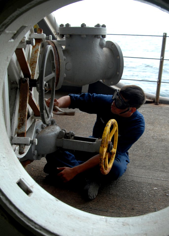 US Navy 081030-N-9134V-117 Seaman Richard Sordia performs maintenance on pipelines