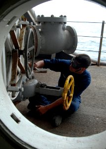 US Navy 081030-N-9134V-117 Seaman Richard Sordia performs maintenance on pipelines