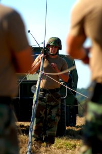 US Navy 081102-N-7367K-001 Seabees assigned to Naval Mobile Construction Battalion (NMCB) 1 erect an OE-254 antenna to establish communications at the logistics support area