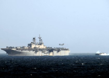 US Navy 081030-N-3392P-102 A CH-46E Super Stallion prepares to land on the flight deck of the multi-purpose amphibious assault ship USS Iwo Jima (LHD 7) as a landing craft air cushion prepares to embark the ship's well deck