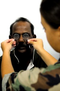 US Navy 081027-N-5642P-127 Lt. Megan Rieman gives a Trinidadian man a general eye exam photo