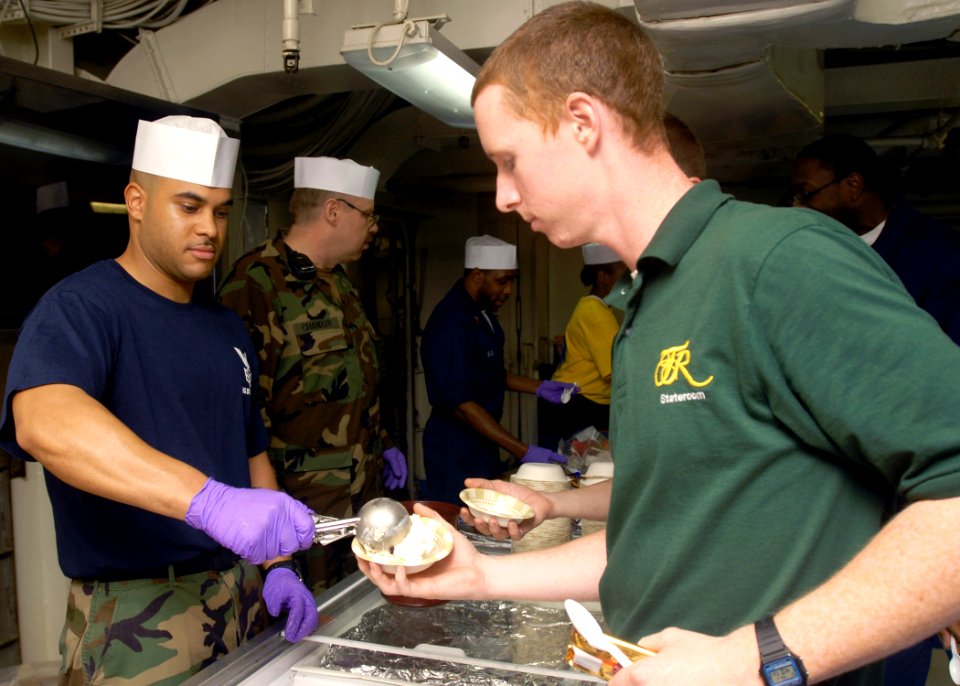 US Navy 081027-N-2456S-108 Master-at-Arms 1st Class Daniel Arroyo scoops ice cream for Aviation Machinist's Mate Airman Steven Dedrick