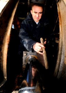 US Navy 081201-N-9898L-057 viation Boatswain's Mate Airman Andres Othon cleans a hydraulic piston