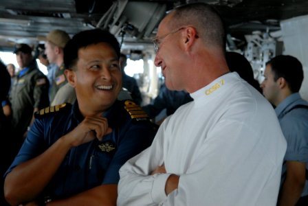 US Navy 081104-N-4005H-329 Rear Adm. Scott Hebner, commander of Carrier Strike Group 7, speaks with a member of the Brunei military during a tour of the bridge aboard the Nimitz-class aircraft carrier USS Ronald Reagan (CVN 76) photo