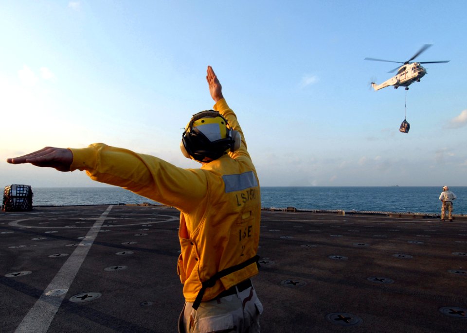 US Navy 081101-N-9134V-063 Boatswain's Mate 3rd Class Joshua Hayes directs a SA-330 Puma helicopter during a vertical replenishment aboard the amphibious dock landing ship USS Carter Hall (LSD 50)