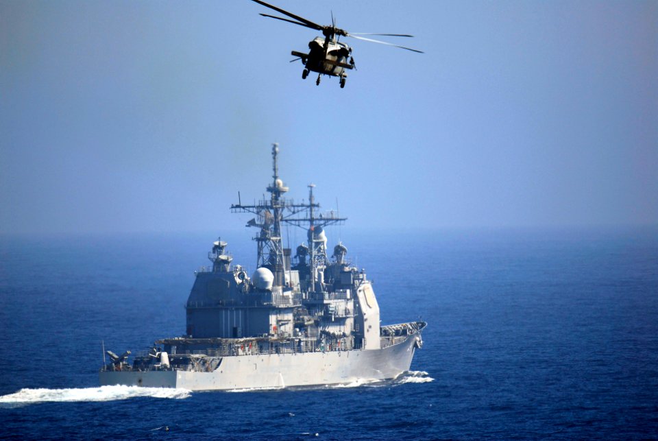 US Navy 081029-N-8157C-129 An MH-60S Sea Hawk flies past the Ticonderoga-class guided-missile cruiser USS Antietam (CG 54)