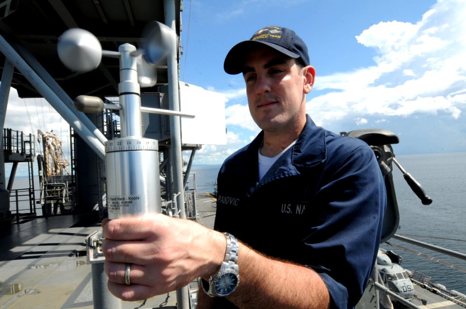 US Navy 081028-N-9774H-006 Aerographer's Mate Airman Matt Palkovic, assigned to Strike Group Oceanographic Team, Norfolk, embarked aboard the amphibious assault ship USS Kearsarge (LHD 3), measures wind speed and direction with
