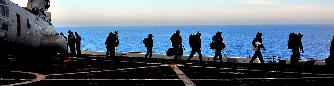 US Navy 081206-N-4774B-070 Marines arriving from Camp Pendleton, Calif. depart a CH-46E helicopter assigned to the