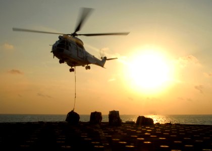 US Navy 081101-N-9134V-152 An SA-330 Puma helicopter delivers cargo during a vertical replenishment with the amphibious dock landing ship USS Carter Hall (LSD 50)