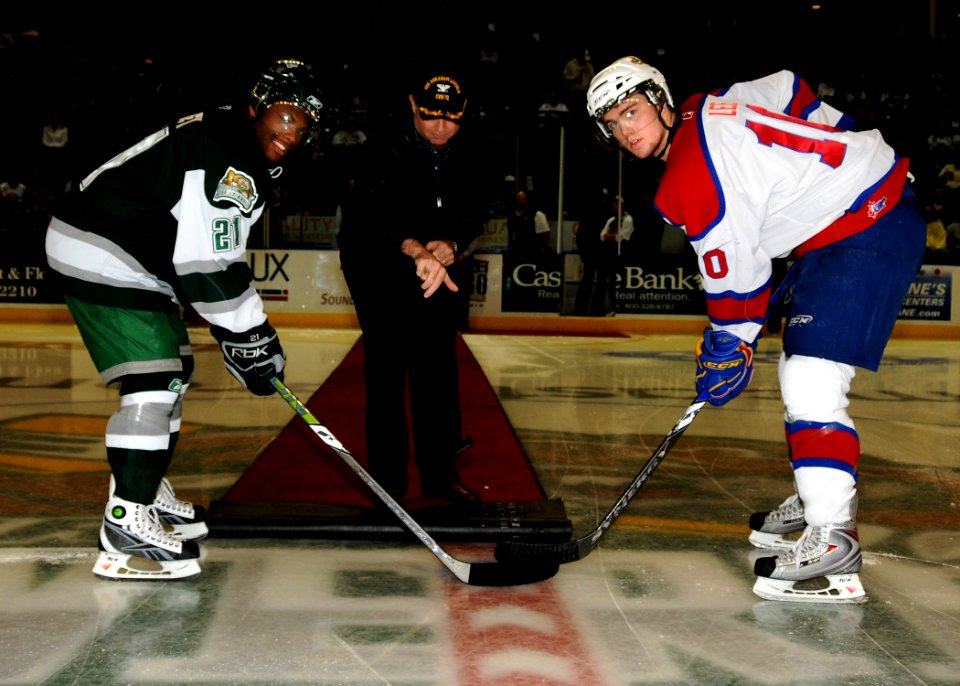US Navy 081101-N-9898L-063 Capt. Patrick Hall, commanding officer of the aircraft carrier USS Abraham Lincoln (CVN 72), drops the ceremonial puck before a local hockey game
