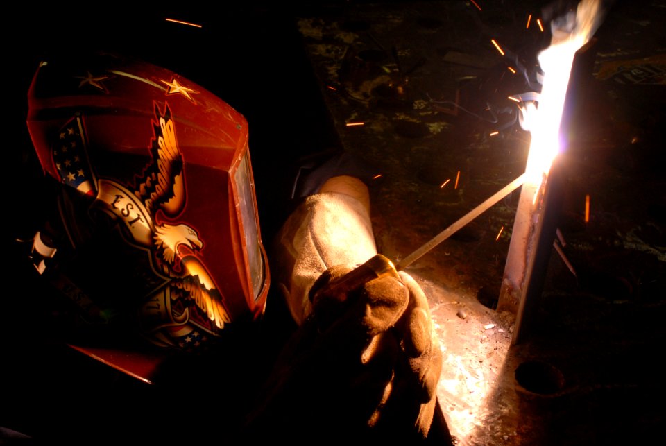 US Navy 081106-N-9132C-112 Hull Maintenance Technician Fireman Laura Vasher stick welds metal aboard the Nimitz-class aircraft carrier USS Ronald Reagan (CVN 76)