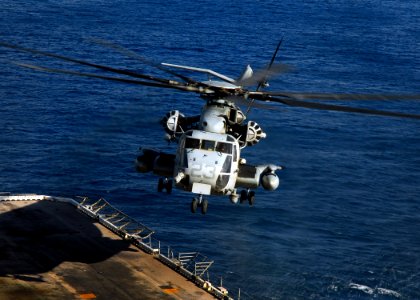 US Navy 081103-N-2183K-058 A CH-53E Super Stallion helicopter descends to the flight deck during operations to disembark Marines