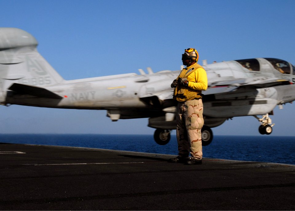 US Navy 081103-N-9900B-007 Chief Aviation Boatswain's Mate (Handling) Richard McCray stands by as an EA-6B Prowler assigned to the