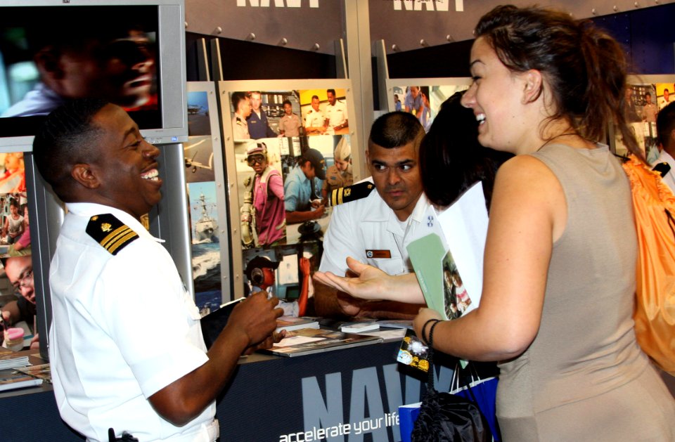 US Navy 081031-N-3446M-828 Lt. Cmdr. Kendrick Brown shares a laugh with a visitor at the Navy exhibit during the American Indian Science and Engineering Society (AISES) 30th Annual National Conference