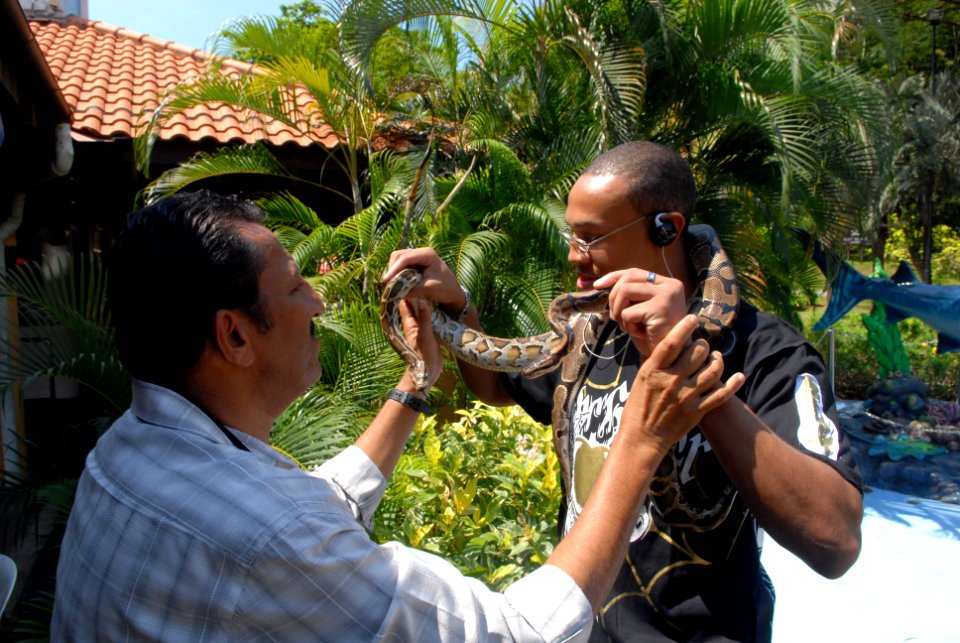 US Navy 081031-N-1635S-004 Yeoman Seaman Darnell Poage, from Chesapeake, Va., visits a snake charmer during a tour to Sentosa Island