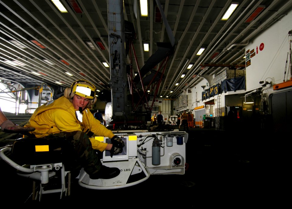 US Navy 081105-N-4236E-014 Aviation Boatswain's Mate (Handling) Airman Timothy Sheets moves aircraft through the hanger bay of the multi-purpose amphibious assault ship USS Iwo Jima (LHD 7)