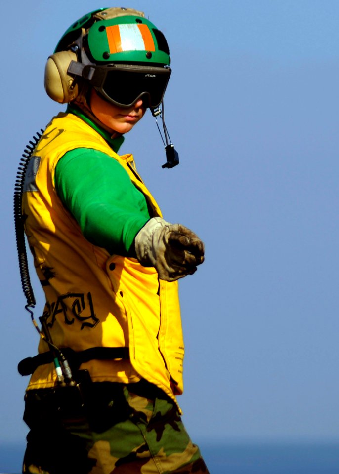 US Navy 081101-N-9900B-002 Aviation Boatswain's Mate (Equipment) 3rd Class Nancey Germann awaits approval from a shooter to launch aircraft