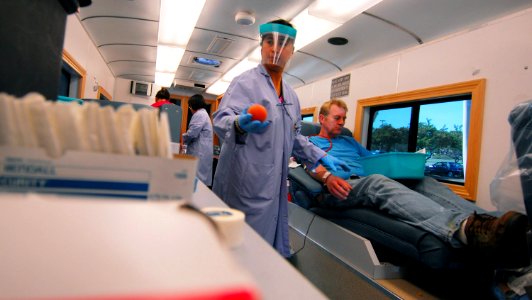 US Navy 081105-N-9689V-002 Maria Luz Roberto draws blood from volunteer donor, Gabriel Verhage