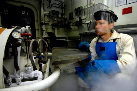 US Navy 081103-N-4954I-027 Machinist's Mate 3rd Class Samuel Strasser fills a liquid oxygen cart