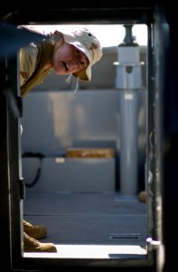 US Navy 081108-N-6932B-132 Construction Mechanic 3rd Class Kristin Loitved assigned to Boat Division 56 relays surface contact coordinates to the navigator and coxswain during a low visibility test